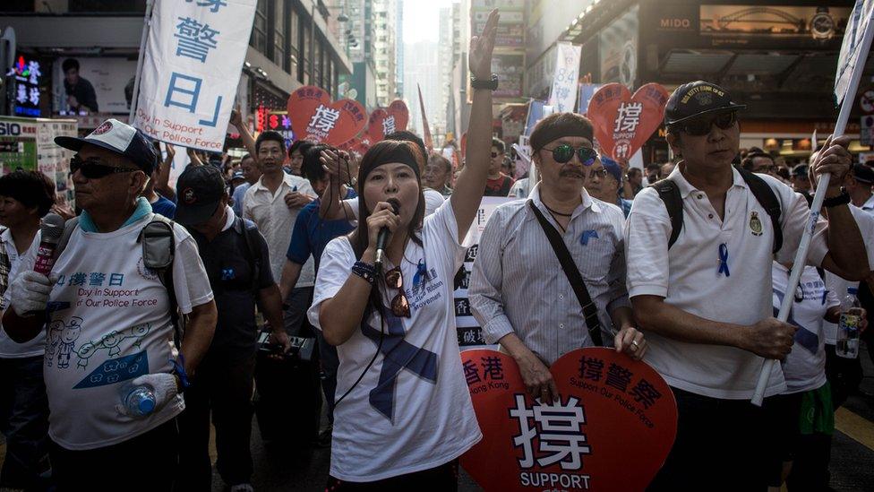 Members of the pro-government Blue Ribbon group march through the streets of Mong Kok to protest the lack of police action against pro-democracy activists on October 12, 2014 in Hong Kong