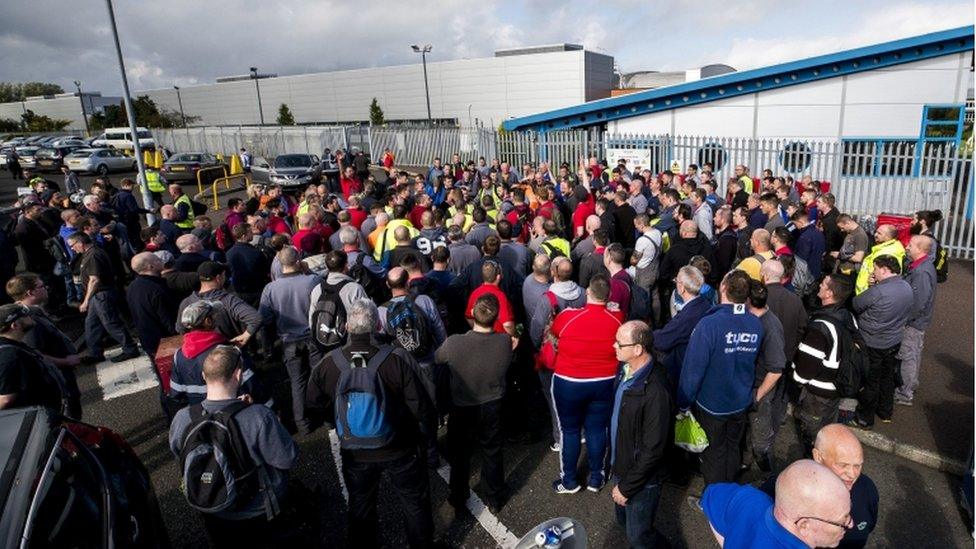 Wrightbus workers gather outside the factory