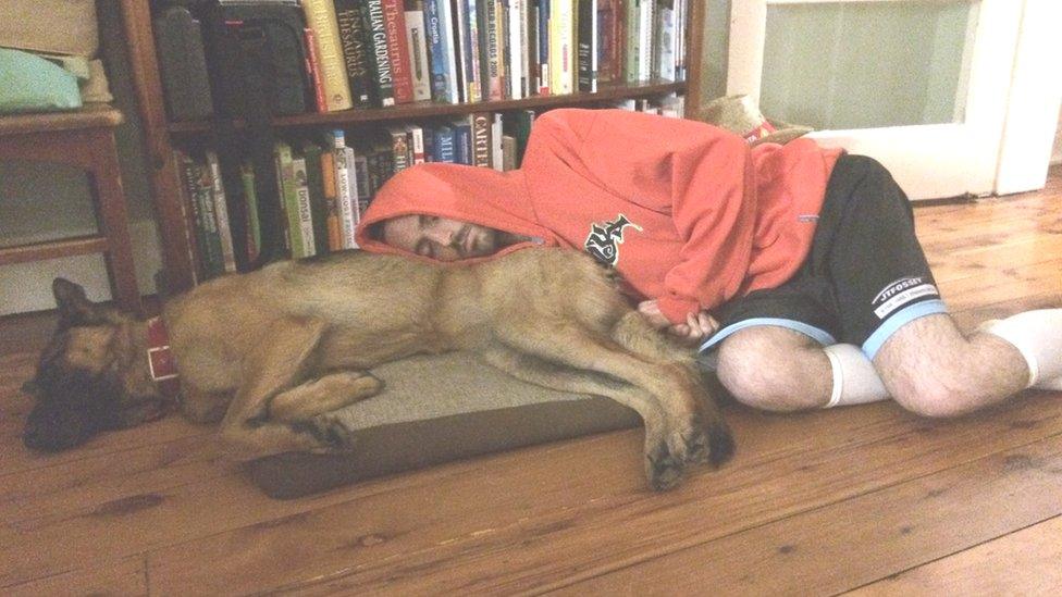 Dan asleep next to his dog