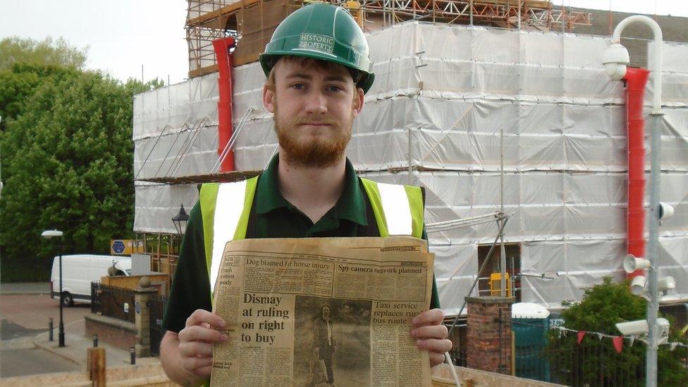 Apprentice Kane with newspaper