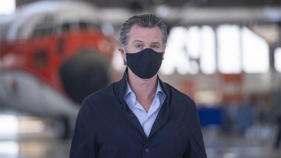 California Governor Gavin Newsom wearing a black face mask visits the California Department of Forestry and Fire Protection