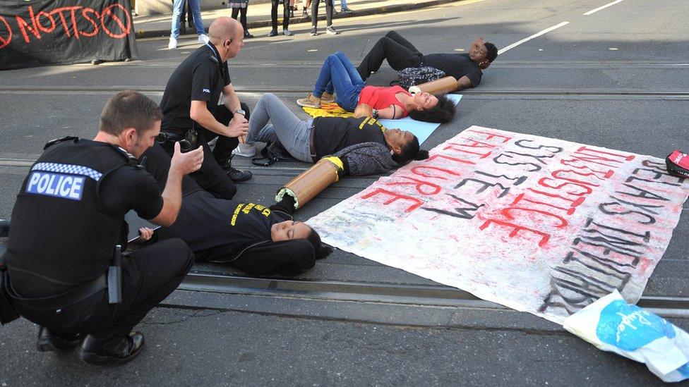 Police officers talk with protesters in Nottingham city centre after activists blocked the tram tracks near Nottingham Theatre Royal to protest for social justice movement Black Lives Matter.