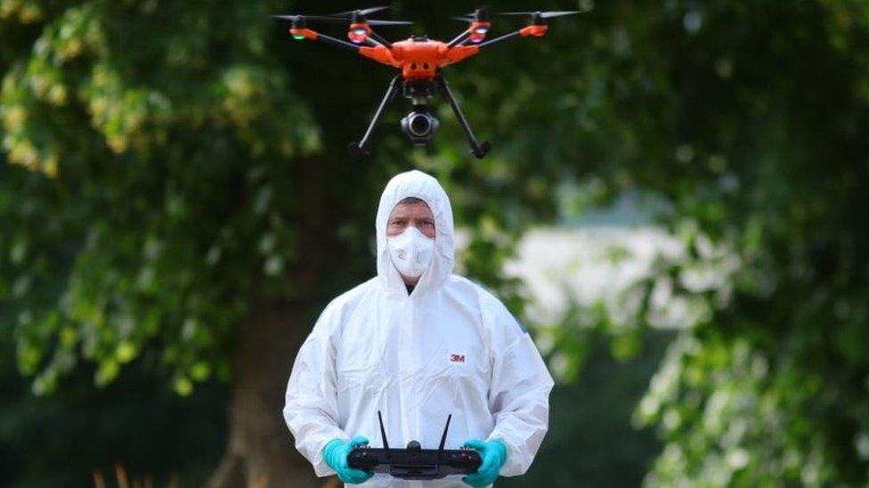 Forensic police fly a drone at Forbury Gardens, in Reading town centre