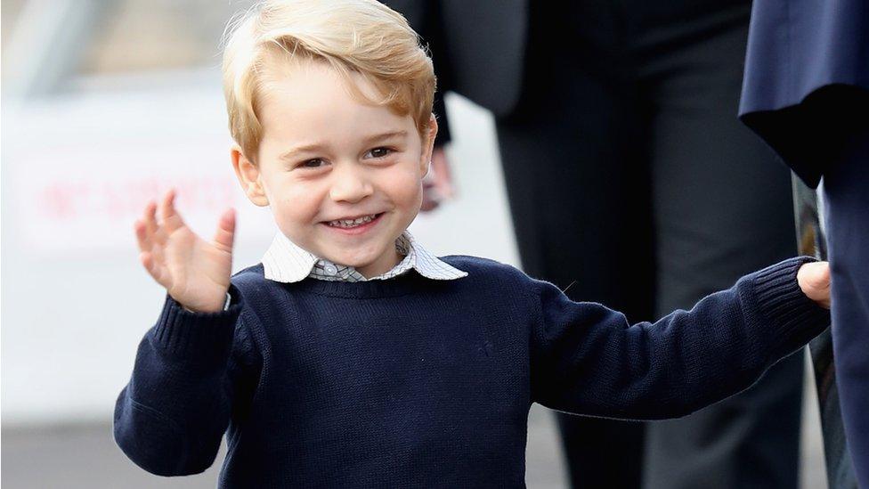 Prince George of Cambridge waves as he leaves from Victoria Harbour, Canada