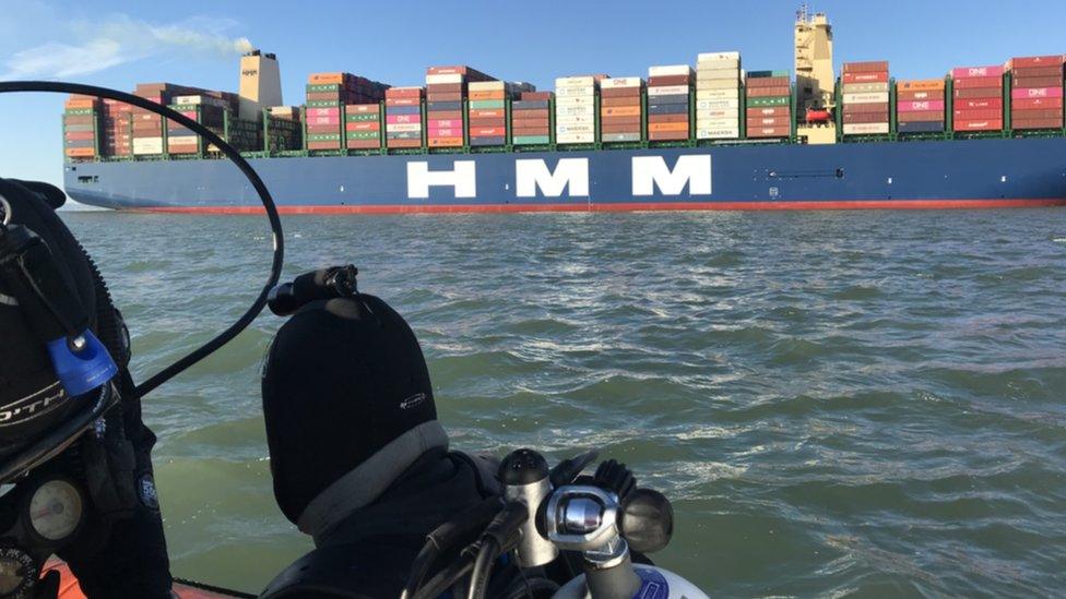 Diver with container ship in background at The London wreck site