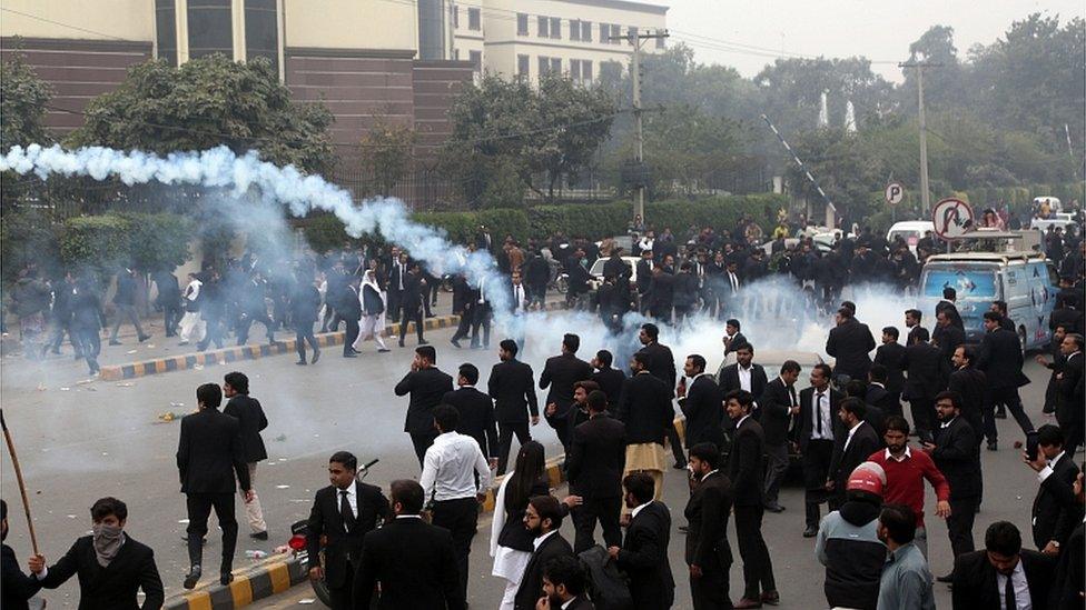 Police fire tear gas during clashes between lawyers and doctors outside the Punjab Institute of Cardiology in Lahore, 11 December 2019