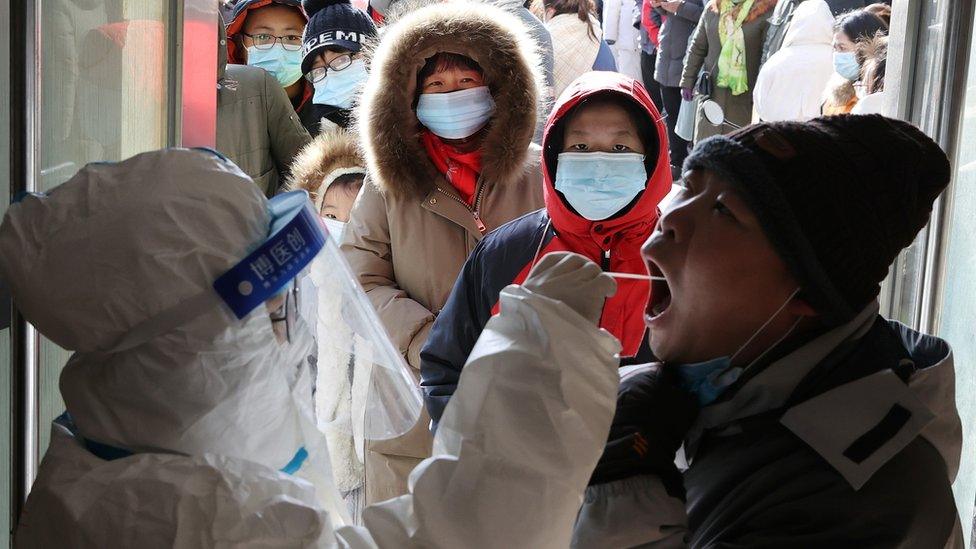 A medical worker tests a resident in Shijiazhuang