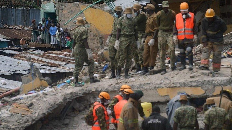 Security and rescue personel search bodies trapped in rubble on May 2, 2016