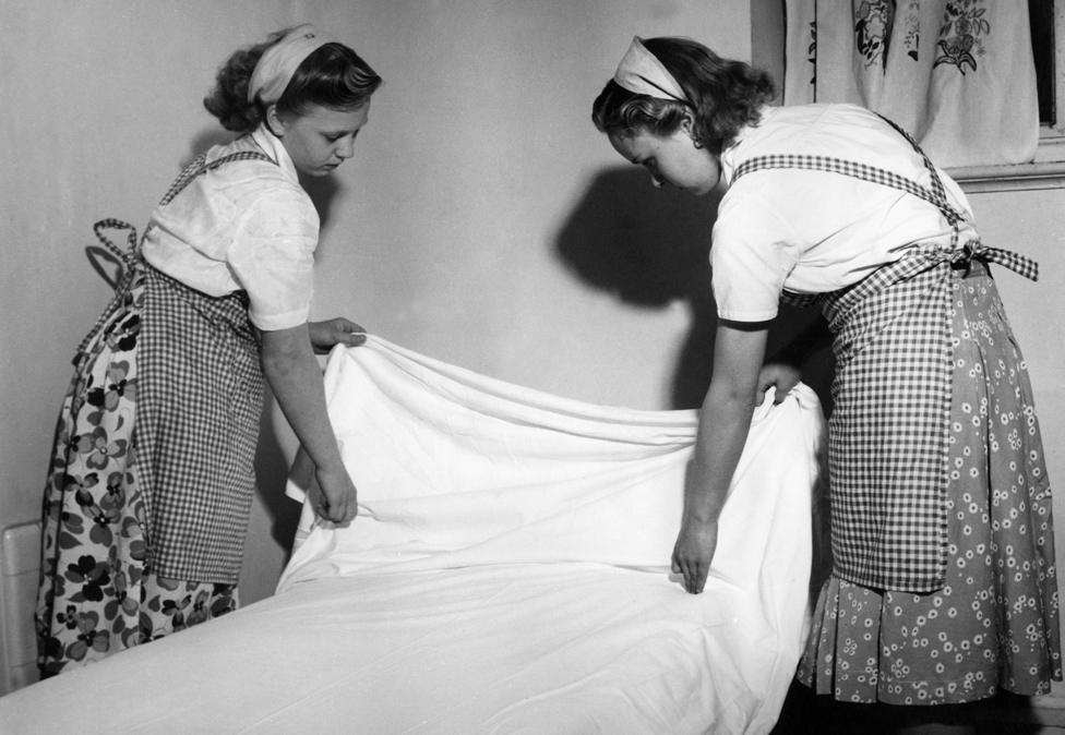 Schoolgirls making bed Great Britain 1950s