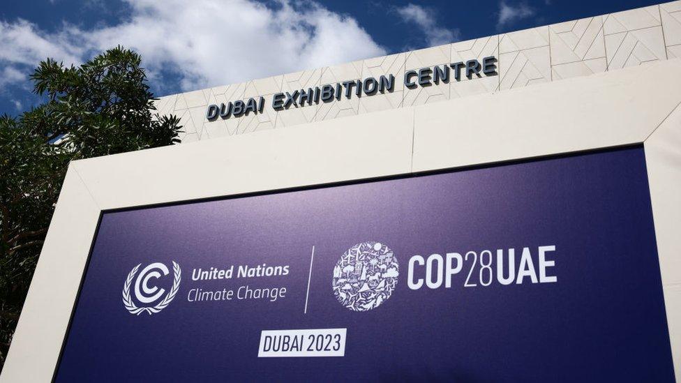 A COP28 sign outside the Dubai Exhibition Centre