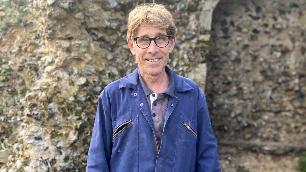 Stonemason Jonathan Presley within the abbey gardens