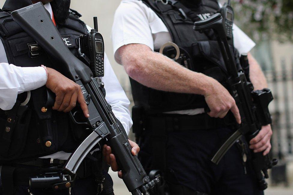 Armed police officers stand in Downing Street