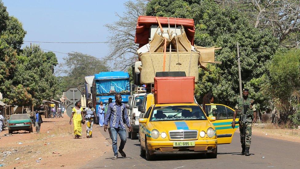 A car piled high with furniture queues at the border post point in Seleki, Senegal - Tuesday 17 January 2017