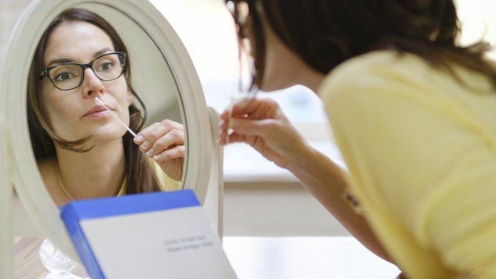 Woman doing a lateral flow test