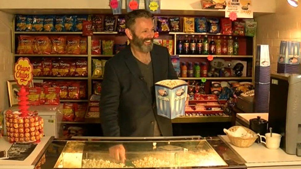 Michael Sheen serving popcorn