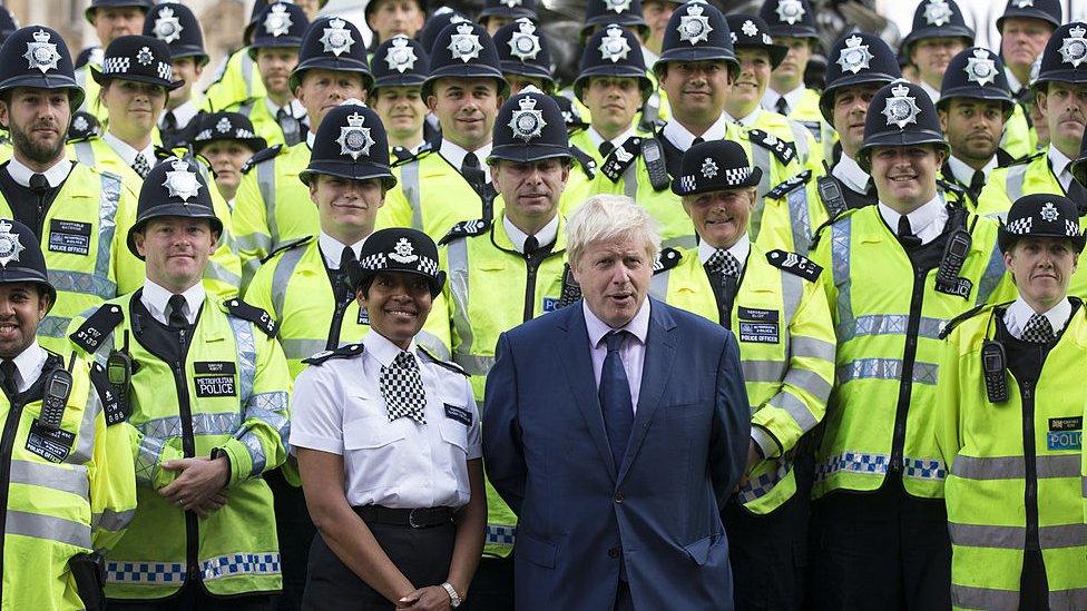 Boris Johnson standing with dozens of police officers