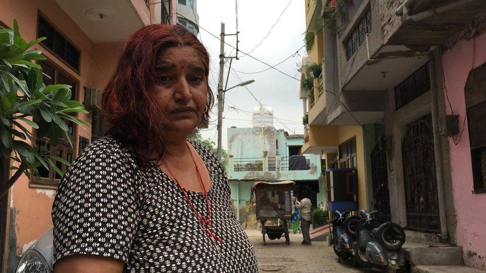 Sunita Devi in front of her house