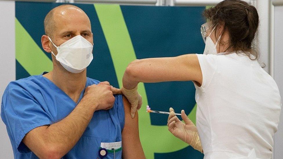 Medical personnel is given the Pfizer vaccine at the Favoriten Clinic in Vienna, Austria