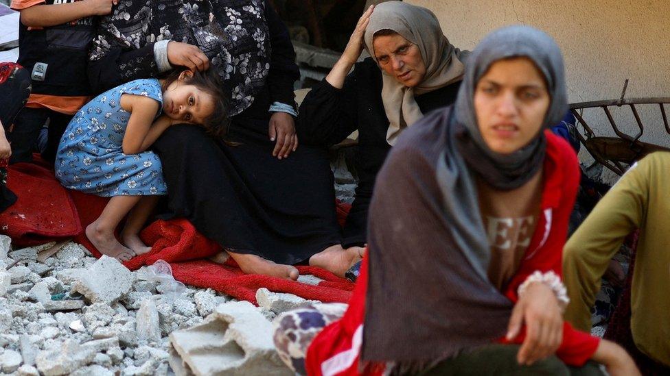 Najah Nabhan, the mother of five disabled Palestinian siblings, whose family was ordered by the Israeli army to leave their apartment before the residential building in which they live was bombed in an Israeli air strike, in the northern Gaza Strip (15 May 2023)