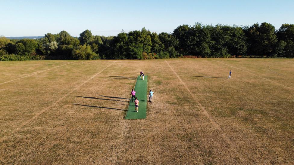 A general view of a dried out grass outfield during a T20 Last Man Stands cricket match between MK Stallions (batting) and MK Super Kings cricket clubs, in Milton Keynes, Britain, 10 August 2022.