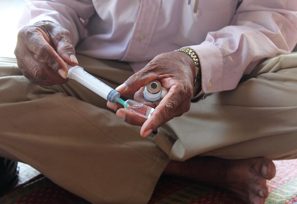 Unidentified doctor holding a syringe