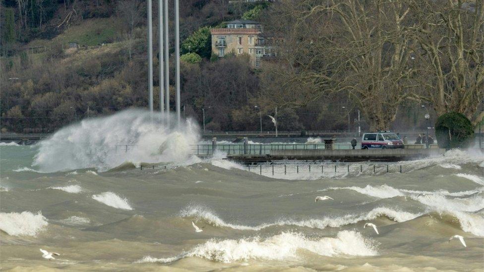 Waves crash into a quay on Lake Constance in Austria