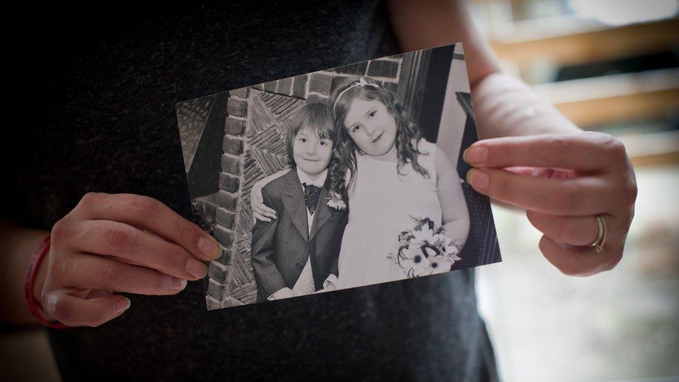 Mandy holds a picture of her son Zac and daughter Millie