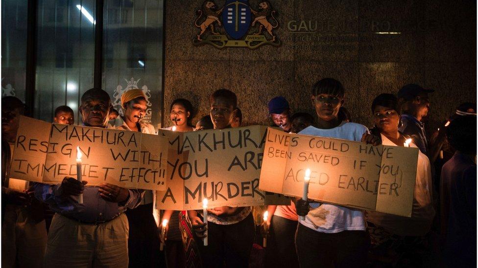 Relatives and family members of some of the 94 mentally ill patients who died last year, hold a candle light vigil organized by South African main opposition party Democratic Alliance (DA) outside the Gauteng Province premier office on February 2, 2017 in Johannesburg.