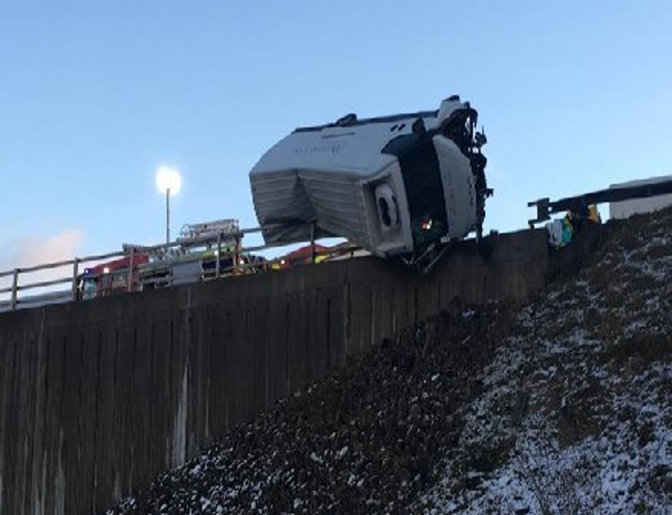 Lorry teetering on motorway bridge