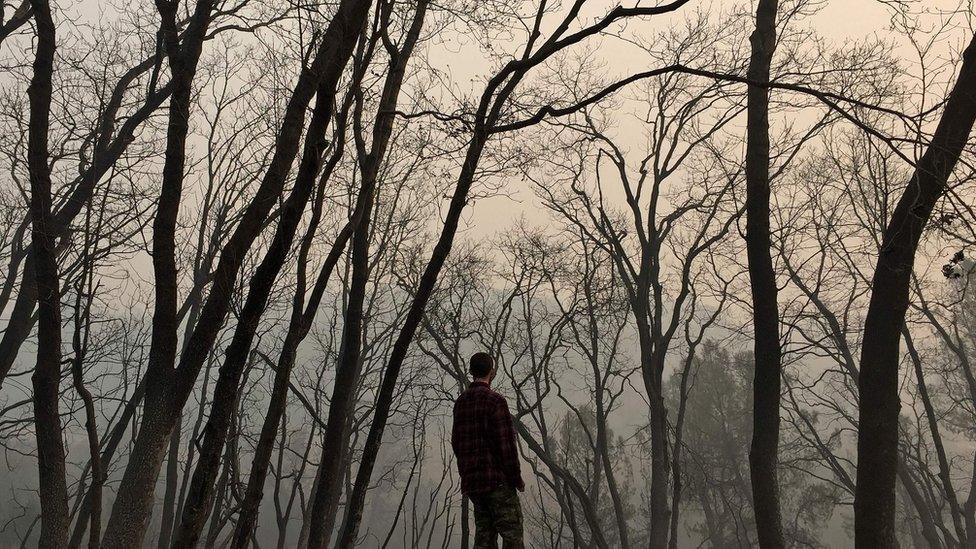 Jhonathan Clark walks in what was his house, destroyed by Camp fire, in Paradise, California, on November 15, 2018