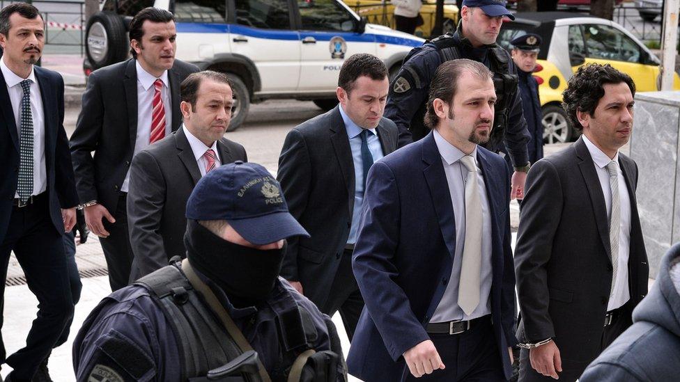 Eight Turkish army officers are escorted by Greek police as they arrive at the Supreme Court, 26 January 2017