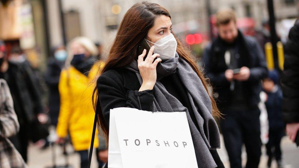 Woman carrying Topshop bag