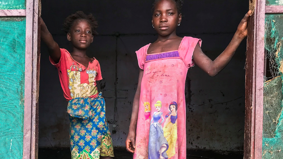 Children stand inside their house covered with mud after Tropical Storm Ana hit Mozambique - 27 January 2022