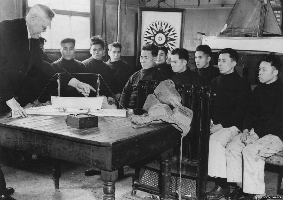 22nd February 1938: Chinese seamen receiving theoretical instruction in the launching of a boat from a ship's deck, as they attend the naval training school at Salthouse Dock in Liverpool