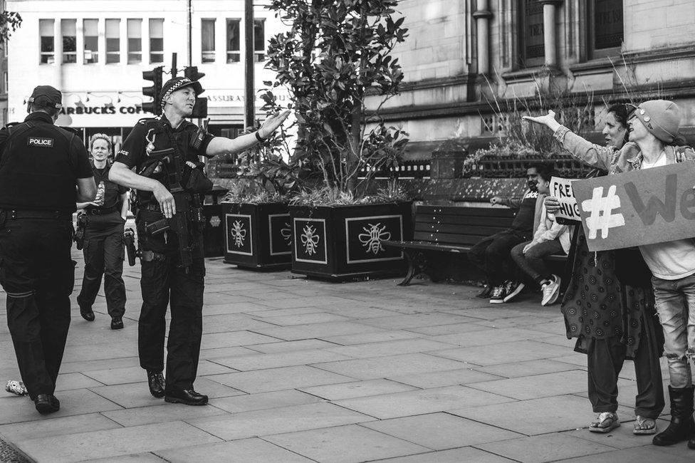 Durham Police officer blowing a kiss to a woman offering free hugs after the Manchester bomb attack