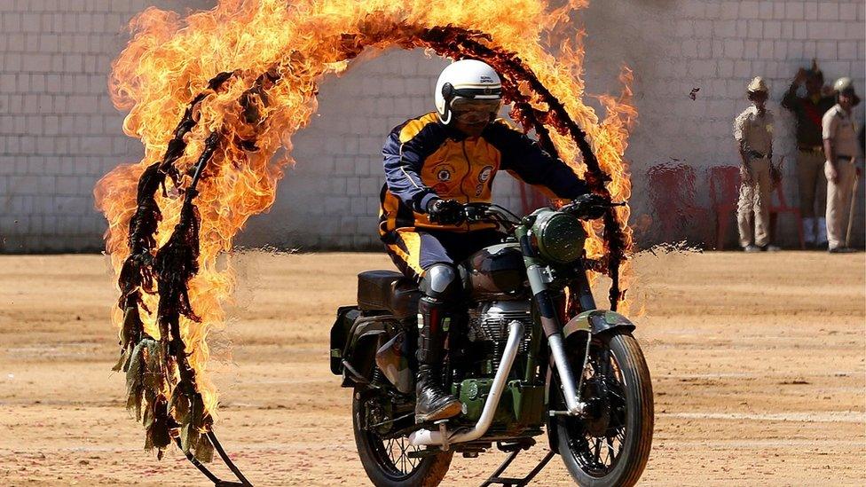 An Indian Army Jawan (soldier) belonging to the "ASC Tornadoes" daredevil bike team performs during the 71st Republic Day celebrations in Bangalore, India, 26 January 2020.