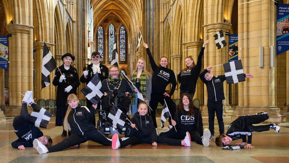 People holding Cornish flags