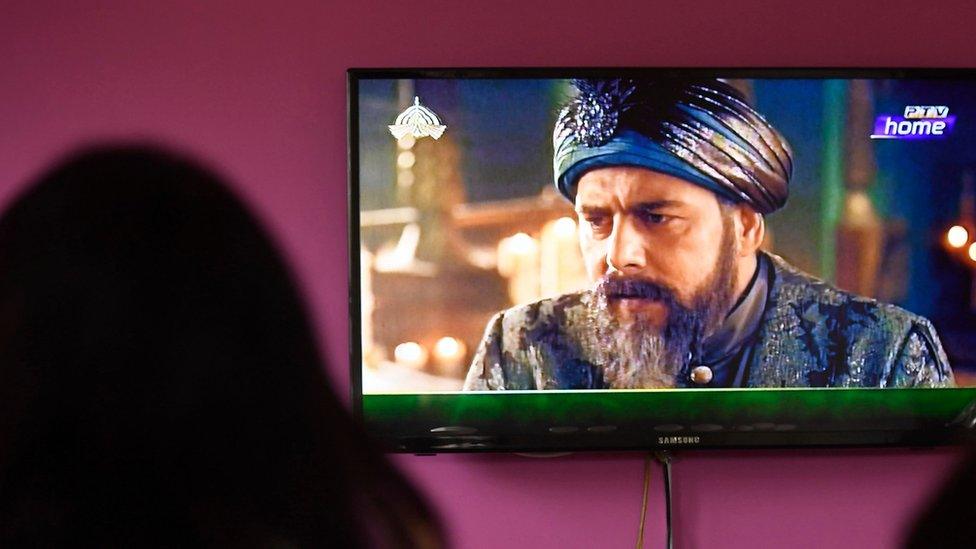 Woman watching the popular TV show Ertugrul