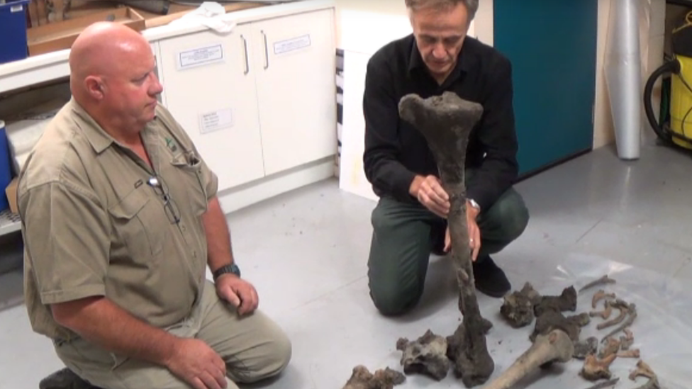 Philip Howe holding a very large bone