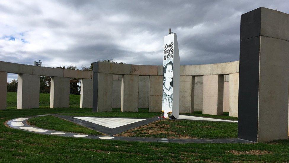 The centre of the "Stonehenge" style artwork with a picture of Queen Elizabeth II in the middle