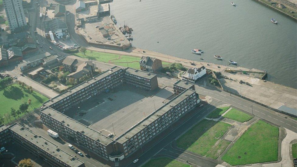 Aerial view of large four sided flat block arranged around a quad