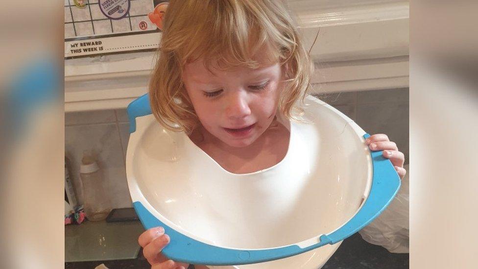 Harper with potty seat around her neck