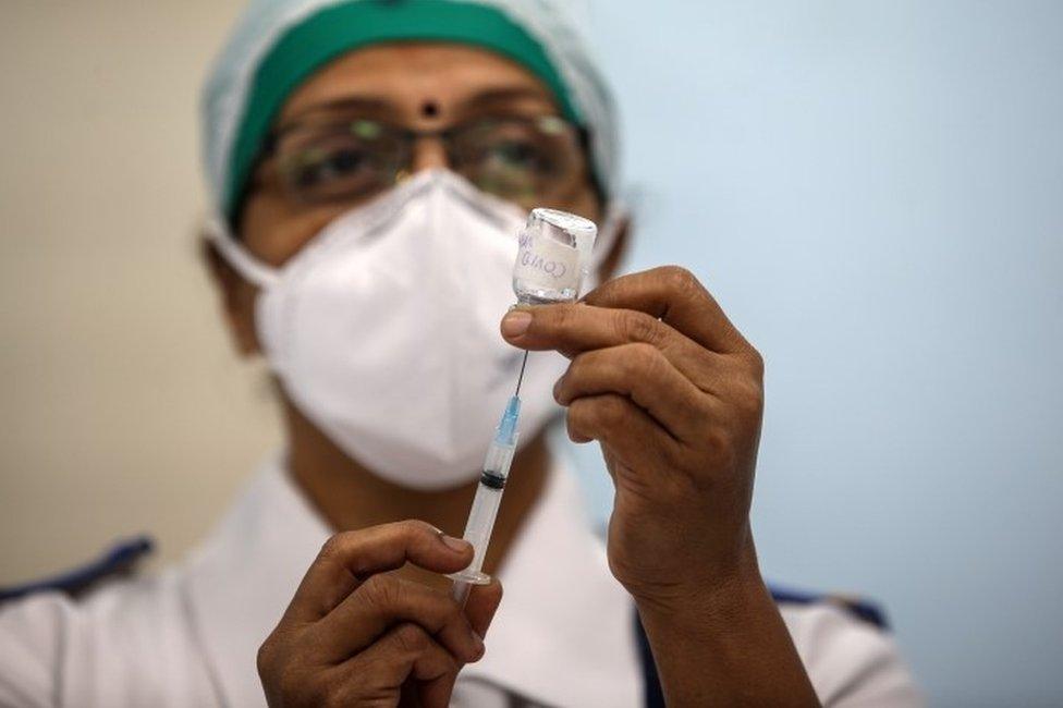 An Indian health worker mocks the vaccination process during a dry run of Covid-19 vaccination inside a Covid-19 vaccination centre at Rajawadi Hospital, in Mumbai, India, 08 January 2021.