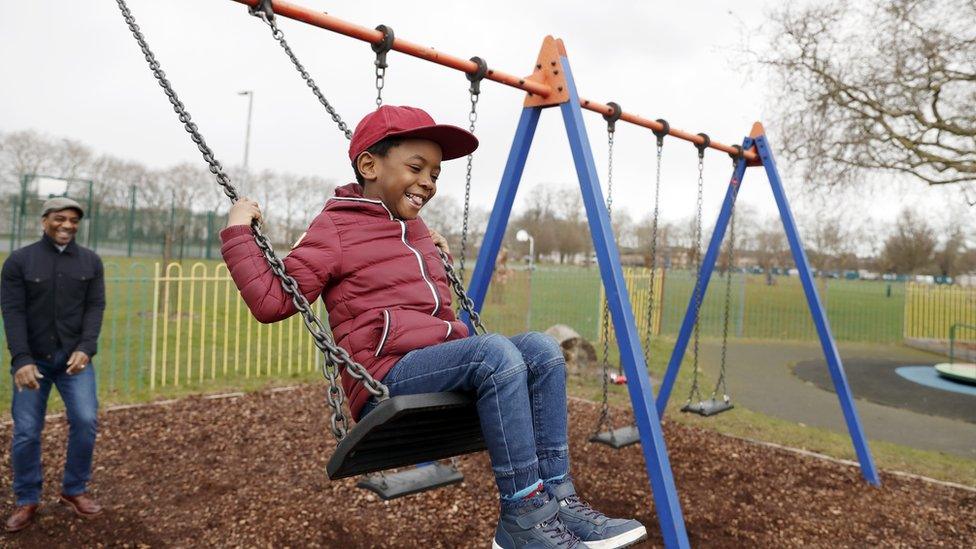 boy-in-the-park-on-a-swing.