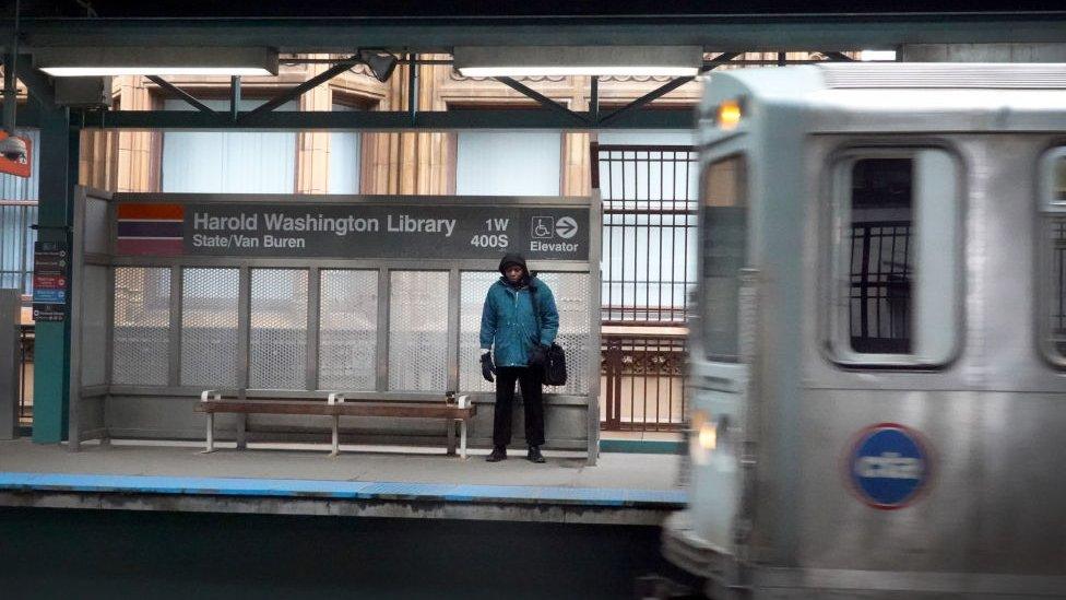 A commuter waits for an "L" train during rush hour in the Loop on March 20, 2020 in Chicago, Illinois.