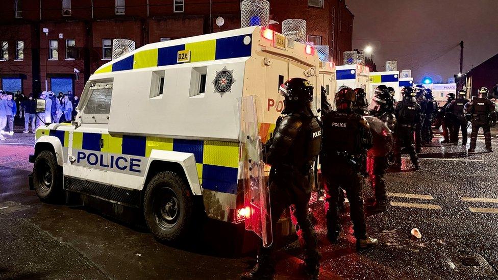 PSNI officers and Land Rovers on the nationalist side of the Springfield Road in Belfast after dispersing people from the area, following further unrest. Picture date: Wednesday April 7, 2021