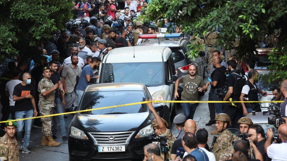 Vehicles are seen outside the Federal bank of Lebanon, after people who were held hostages exited the bank, in Hamra, Lebanon, August 11, 2022. REUTERS/Mohamed Azakir