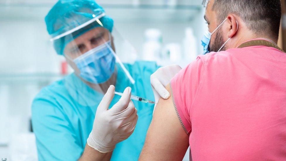 Doctor with volunteer having vaccine