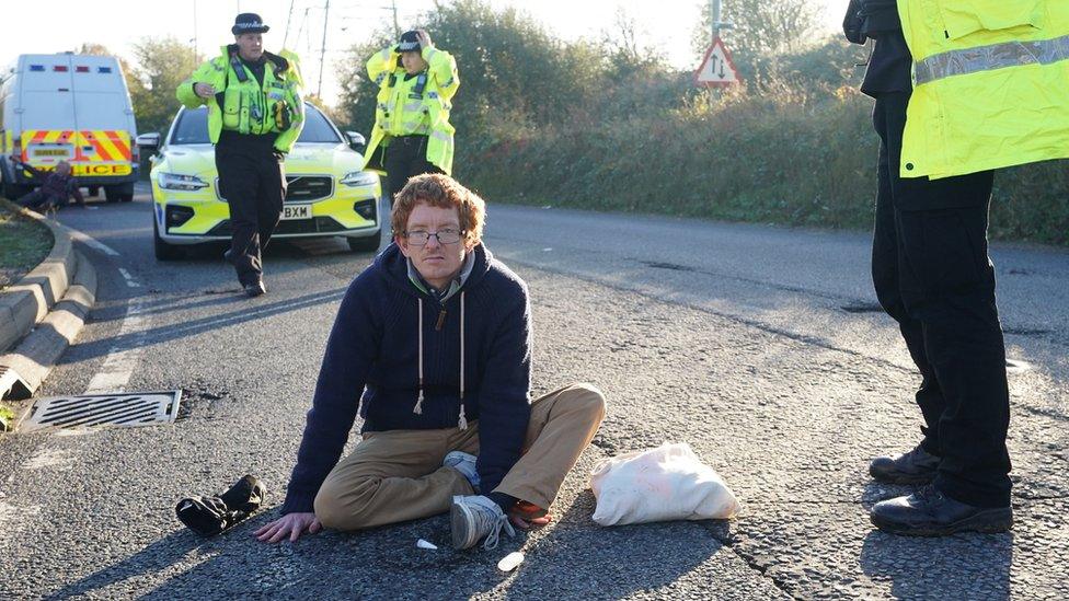 Protesters on a road with police