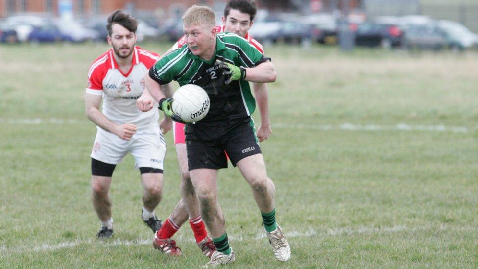 Action from the Irish Guards' (in black and green) first game of Gaelic football